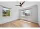 A bright bedroom with hardwood floors, large windows, and a modern ceiling fan at 1130 N Pennsylvania St # 208, Denver, CO 80203
