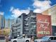 Modern building with a red brick facade and open-air balconies, adding an architectural character at 1130 N Pennsylvania St # 208, Denver, CO 80203