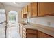 Bright eat-in kitchen featuring shaker cabinets, neutral countertop and views through the window at 1130 N Pennsylvania St # 208, Denver, CO 80203