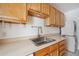 Bright kitchen featuring shaker cabinets, in-unit washer and dryer and stainless steel sink at 1130 N Pennsylvania St # 208, Denver, CO 80203