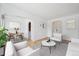Open-concept living room with hardwood floors, comfortable seating, and adjacent dining area at 1130 N Pennsylvania St # 208, Denver, CO 80203