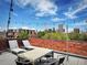 Relaxing roof deck with lounge chairs and outdoor seating area showcasing amazing views of the city skyline at 1130 N Pennsylvania St # 208, Denver, CO 80203