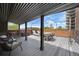 Relaxing rooftop deck with outdoor seating, city views and decorative string lights at 1130 N Pennsylvania St # 208, Denver, CO 80203