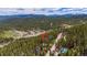 Wooded mountain community with a pond nearby with easy access to the mountain vista in the distance at 542 Harris Dr, Idaho Springs, CO 80452