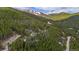 A wooded mountain community featuring tree coverage and mountain vistas in the distance at 542 Harris Dr, Idaho Springs, CO 80452