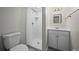 Bright bathroom with a walk-in shower, updated vanity, lighting and fixtures at 542 Harris Dr, Idaho Springs, CO 80452