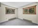 Bright bedroom featuring neutral walls, soft gray carpet and a pair of windows with lovely woodland views at 542 Harris Dr, Idaho Springs, CO 80452