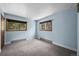 Carpeted bedroom with two windows offering natural light and lovely wooded views at 542 Harris Dr, Idaho Springs, CO 80452