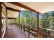 Expansive deck with wood railing overlooking a lush green forest at 542 Harris Dr, Idaho Springs, CO 80452