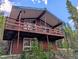 Exterior angle view of a two-story home with a large wooden balcony at 542 Harris Dr, Idaho Springs, CO 80452