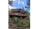 Rustic home with a spacious balcony, nestled amongst lush trees and foliage at 542 Harris Dr, Idaho Springs, CO 80452