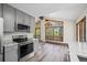 Well-lit open kitchen with stainless steel appliances and gray cabinets, perfect for entertaining at 542 Harris Dr, Idaho Springs, CO 80452