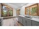 Modern kitchen boasts a sleek design with gray cabinetry, granite counters, and scenic views at 542 Harris Dr, Idaho Springs, CO 80452