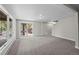 Spacious living room featuring neutral paint, carpet, and large windows with sliding glass door at 542 Harris Dr, Idaho Springs, CO 80452