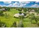 Beautiful aerial view of community pond surrounded by lush greenery and mature trees at 907 Eldorado Dr, Superior, CO 80027