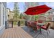 Inviting outdoor deck with a dining set, grill, and a large red umbrella perfect for entertaining and enjoying the backyard views at 907 Eldorado Dr, Superior, CO 80027