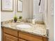 Bathroom featuring granite countertops, stainless faucet and wood cabinets at 907 Eldorado Dr, Superior, CO 80027