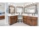 Bright bathroom featuring double vanities, updated fixtures, vanity stool, and three large mirrors at 907 Eldorado Dr, Superior, CO 80027