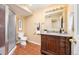 Bathroom with tiled floors, shower stall, stained wood vanity and large mirror at 907 Eldorado Dr, Superior, CO 80027