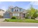 Charming two-story home with a well-manicured lawn, lush landscaping, and a lovely brick facade at 907 Eldorado Dr, Superior, CO 80027