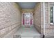 Inviting front porch with a brick surround and a charming doorway, perfect for welcoming guests at 907 Eldorado Dr, Superior, CO 80027
