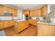 Spacious kitchen featuring wood cabinets, granite countertops, stainless steel appliances, and a center island at 907 Eldorado Dr, Superior, CO 80027