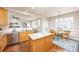 Open kitchen with wood cabinets, a center island with granite countertops, and stainless steel appliances at 907 Eldorado Dr, Superior, CO 80027