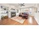 Cozy living room with a fireplace, built-in shelves, hardwood floors, and a ceiling fan at 907 Eldorado Dr, Superior, CO 80027