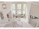 Bright, open living room with high ceilings, large windows, and a staircase at 907 Eldorado Dr, Superior, CO 80027