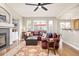 Bright living room with fireplace, hardwood floors, built-in shelving, and a large window at 907 Eldorado Dr, Superior, CO 80027