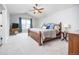 Bright main bedroom features vaulted ceilings, ceiling fan, large window with blue curtains, and en suite bathroom at 907 Eldorado Dr, Superior, CO 80027