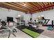 Unfinished basement with exposed beam ceiling, fitness equipment, and two windows at 8033 Galileo Way, Littleton, CO 80125