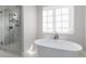 Modern bathroom with a glass enclosed shower and a free standing bathtub at 8033 Galileo Way, Littleton, CO 80125