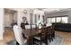 Spacious dining room featuring a modern chandelier, white trim, and scenic views through the large windows at 8033 Galileo Way, Littleton, CO 80125