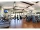 Well-equipped fitness center with modern exercise equipment, hardwood floors, and ample natural light at 8033 Galileo Way, Littleton, CO 80125