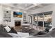 Cozy living room boasts a fireplace, built-in shelving, and patio doors leading to an outdoor space at 8033 Galileo Way, Littleton, CO 80125
