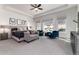 Serene main bedroom features plush carpeting, ample natural light, and comfortable seating area at 8033 Galileo Way, Littleton, CO 80125