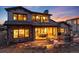 Stately home with a stone and stucco exterior, plus an expansive patio and outdoor living space at 8033 Galileo Way, Littleton, CO 80125