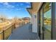 A large back deck features modern railings with views of the back lawn at 804 Spyglass Cir, Louisville, CO 80027