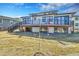 The back exterior features a large deck with a staircase overlooking the spacious backyard at 804 Spyglass Cir, Louisville, CO 80027