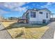 Beautiful modern home and back yard with a deck and gravel walkway at 804 Spyglass Cir, Louisville, CO 80027