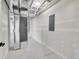 Basement hallway with white walls and trim and gray electric panel at 804 Spyglass Cir, Louisville, CO 80027