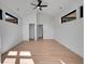 Open bedroom featuring light hardwood floors and two large windows at 804 Spyglass Cir, Louisville, CO 80027