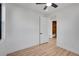 Bedroom with ceiling fan, view of ensuite bath, closet, and wood-look flooring at 804 Spyglass Cir, Louisville, CO 80027