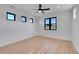 Bright bedroom with sleek, black frame windows and light hardwood floors at 804 Spyglass Cir, Louisville, CO 80027
