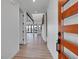 Hallway view to open concept living area, black steel beam, and wood floors at 804 Spyglass Cir, Louisville, CO 80027