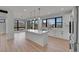 Bright kitchen featuring a large center island and an open concept to the living area at 804 Spyglass Cir, Louisville, CO 80027
