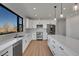 Modern kitchen with white cabinets, stainless steel appliances, and a large center island at 804 Spyglass Cir, Louisville, CO 80027