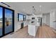 Modern kitchen with white cabinets, stainless steel appliances, and a large center island at 804 Spyglass Cir, Louisville, CO 80027