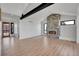 Spacious living room featuring a stone fireplace, black steel beam, and light wood flooring at 804 Spyglass Cir, Louisville, CO 80027
